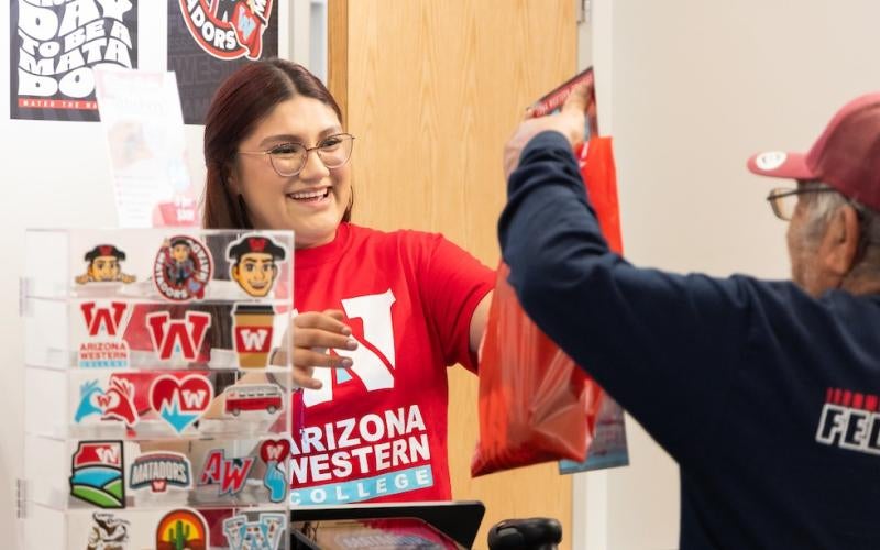 Student worker helps a customer at the Matador Merch grand opening in March 2025.