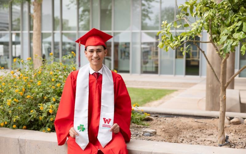 2026 Early College graduate from Yuma Catholic poses in cap and gown