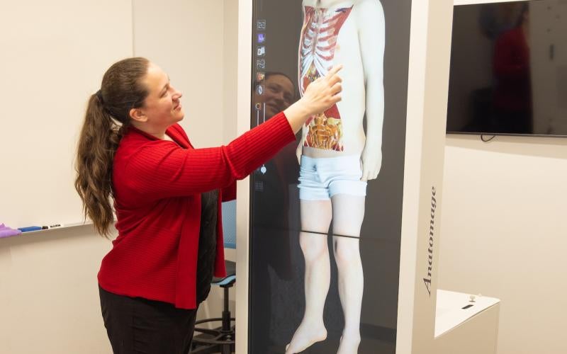 Professor demonstrates the Anatomage simulation table in the AWC Makerspace