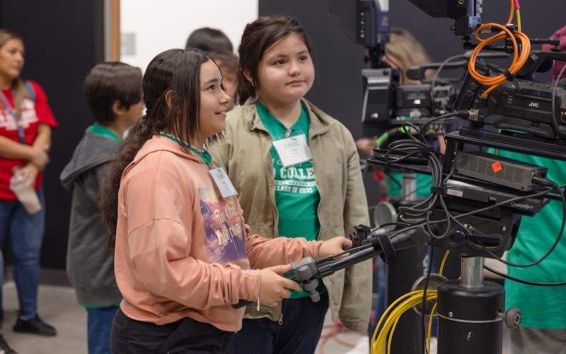 Students test out video equipment in the KAWC/KOFA-Border Radio Video Production Studio during the I'm Going to College event in November 2023.