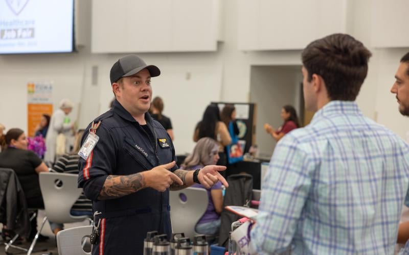 A representative from Aero Care Medical Transport shares about career opportunities at the 2023 Healthcare Job Fair hosted by AWC.