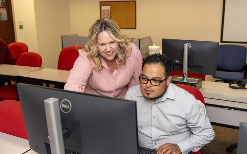 AWC staff member assists a student in the Adult Education program