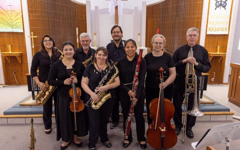 Smiling AWC Music Faculty hold their instruments at St. Paul's Episcopal Chapel during the 2024 Spring Faculty Concert.