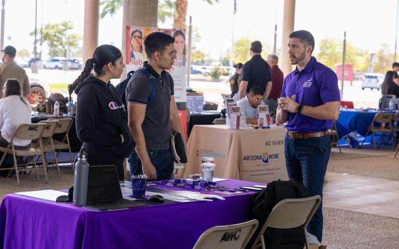 Students talk to a Grand Canyon University representative at the 2024 Desert Southwest Transfer Conference.