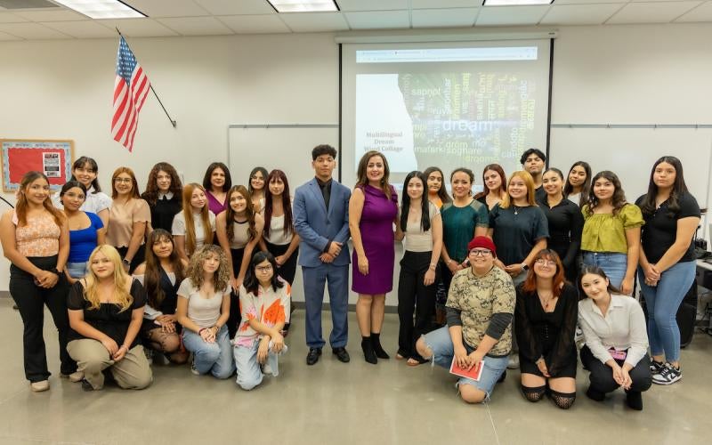 Dr. Sara Amani, AWC Professor of Multilingual Composition/Specialist, stands with her First-Year English Composition students at the Sixth Multilingual Student Expo in October 2024.