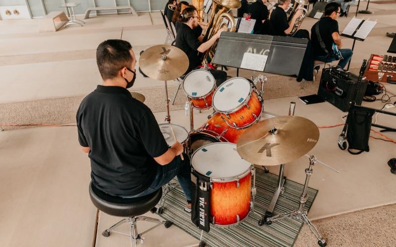 Drummer performs at the AWC Pep Band Fall Patio Concert in 2023.