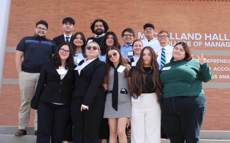 AWC Business Club students stand on the steps to McClelland Hall at the University of Arizona Eller College of Management in Phoenix, Arizona.