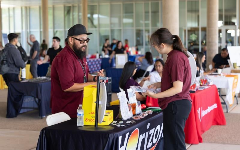 Student speaks with a representative from Horizon Health & Wellness at the Yuma Transfer and Career Expo in October 2025.
