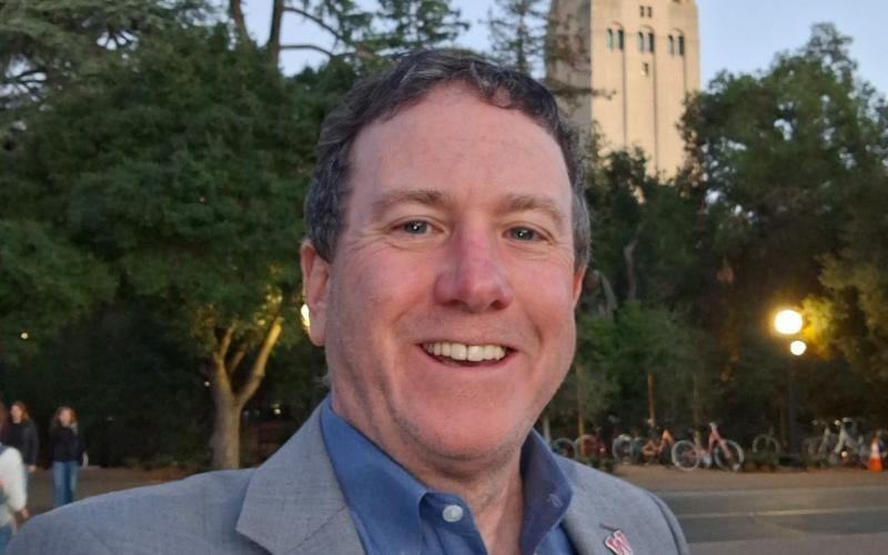 AWC President Dr. Daniel Corr stands on the campus of Stanford University (Palo Alto, CA) with the Hoover Tower behind him.