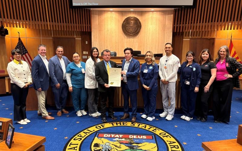 Arizona Western College leadership and student representatives stand inside the Arizona State Capitol building with Senator Tim Dunn and Senator Brian Fernandez.