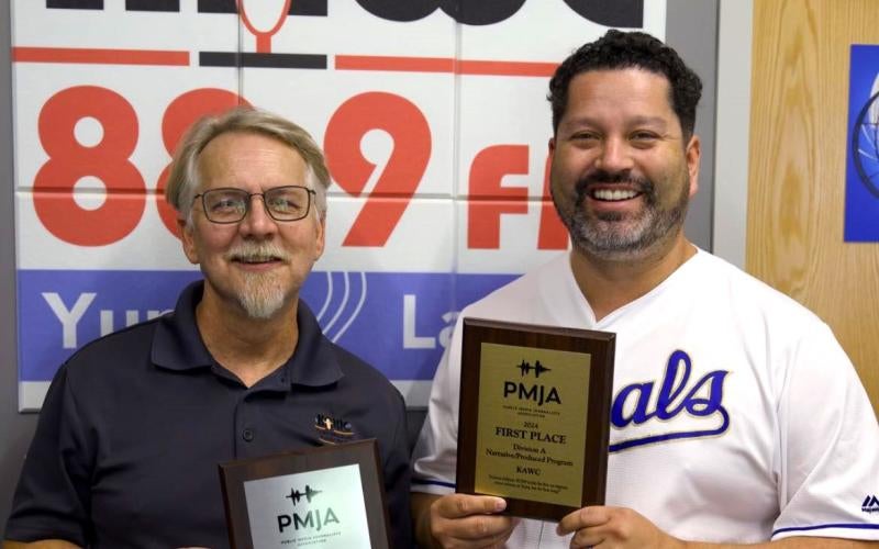 Lou Gum (left) and Victor Calderón (right) pose with their PMJA awards in the KAWC studio.