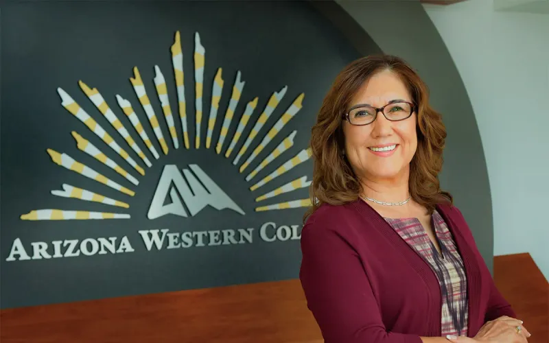 Olivia Zepeda poses in front of the Arizona Western College logo.