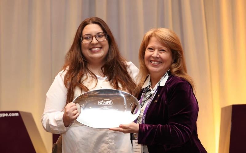 Sarah Herman receives the National Communicator of the Year award from NCMPR President Virginia Moreland