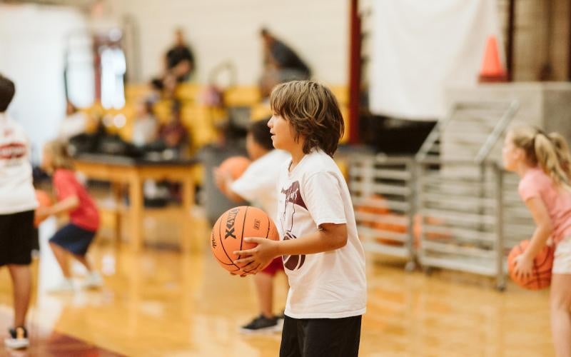 Students learn basketball fundamentals at the 2024 Chapman Automotive Summer Basketball Camp.