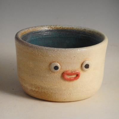 Photo of ceramic bowl, has a face