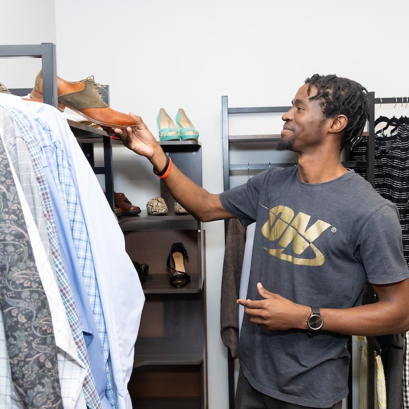 Student selecting some shoes at The Cubby