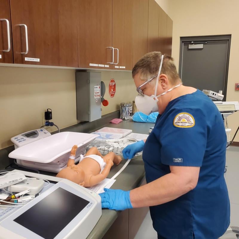 Medical Assistant Student measuring a baby