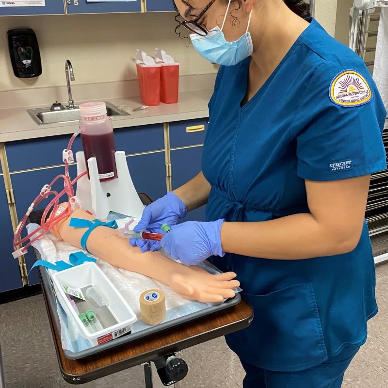 Medical Assistant Student practicing Phlebotomy