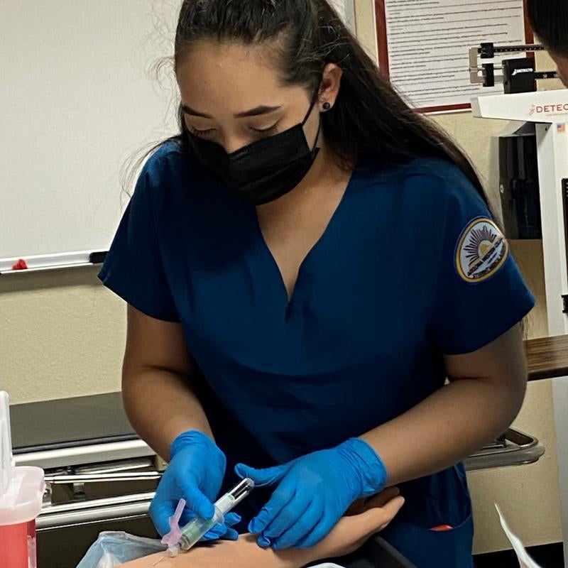 Medical Assistant Student practicing Phlebotomy