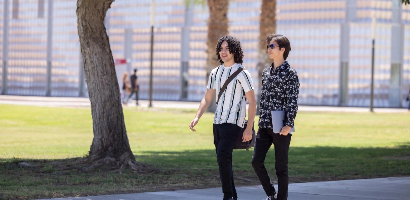 Two male students walking on Yuma Campus