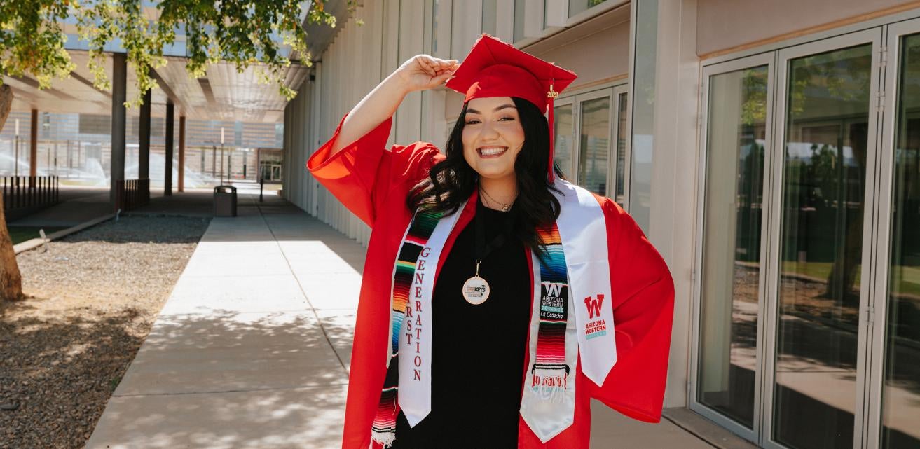 A smiling female student wearing her cap and gown