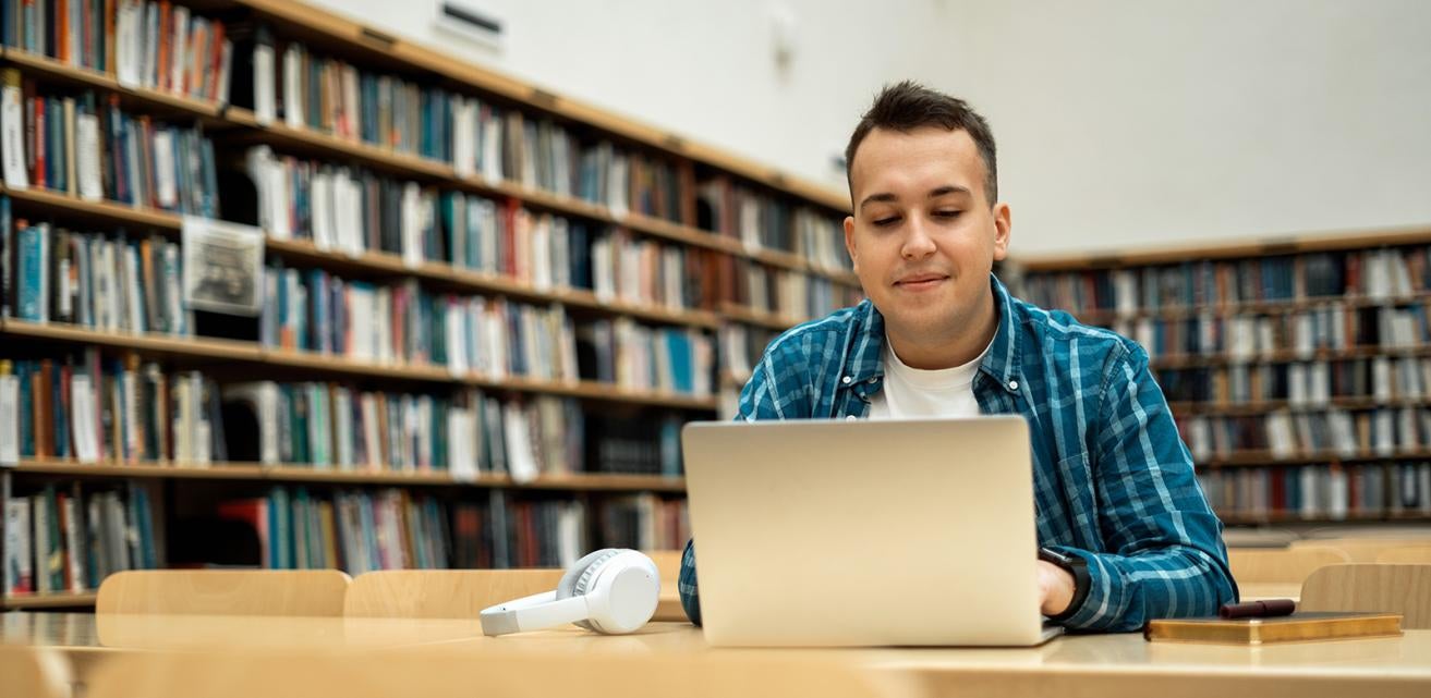 Student on laptop in library