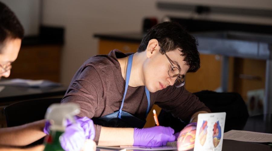 Student taking notes in class