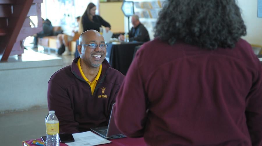 Arizona State University Representative speaking to a student